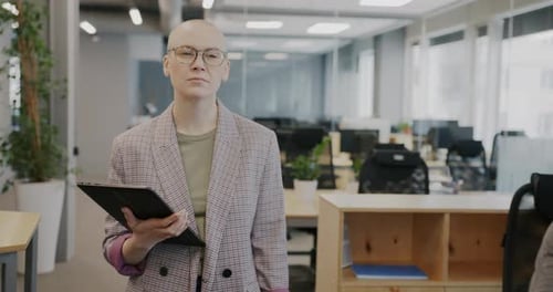 Portrait of Businesswoman Walking in Office Using Tablet Touching Screen and Looking at Camera