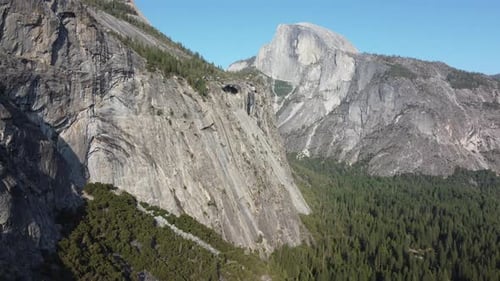 Yosemite National Park, the clip shows a backward movement away from the half dome and a mountain cl