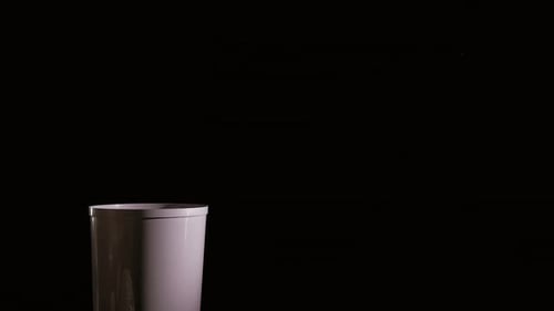 Throw Paper Trash Into Bin on Black Background Indoor