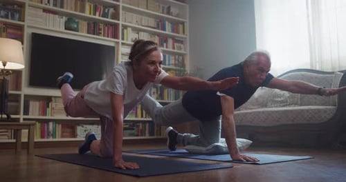 Mature Couple Exercising Together at Home