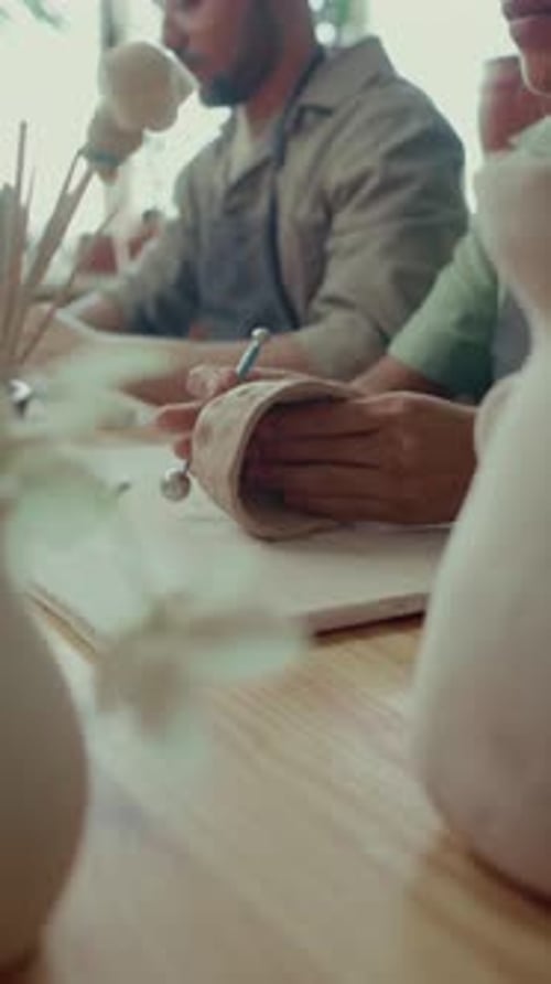 Female Artisan Sculpting Mug out of Clay while Working in Potters Studio