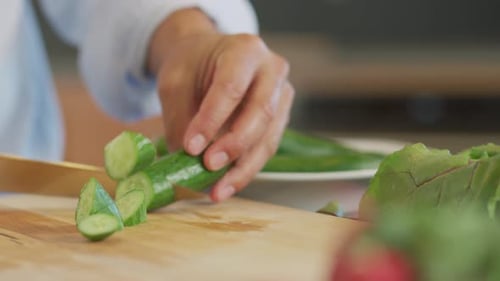 Close Up Shot Of Man Cutting Cucumber