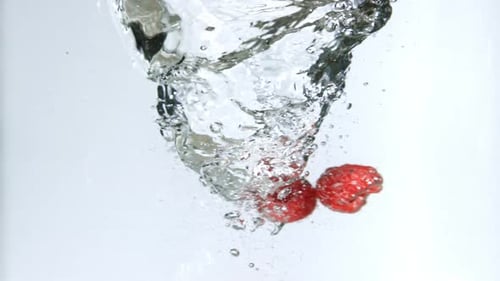 Fresh Raspberries Fall Into the Whirlpool
