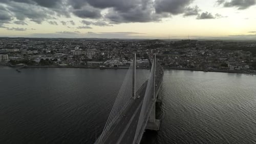 Dramatic Aerial View of a Modern Cable-Stayed Bridge at Sunset
