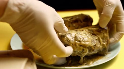 Hands Prepare Stuffed Meat for Beef Wellington