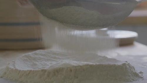 Flour Being Sieved for Baking Preparation Close Up