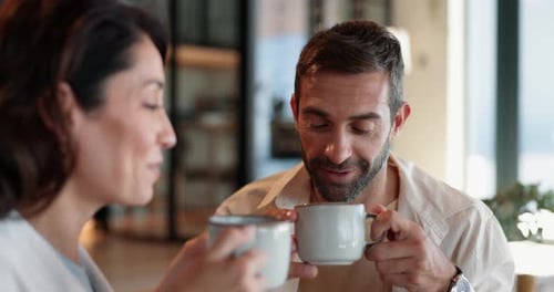 Man and Woman Drinking Coffee Together and Smiling