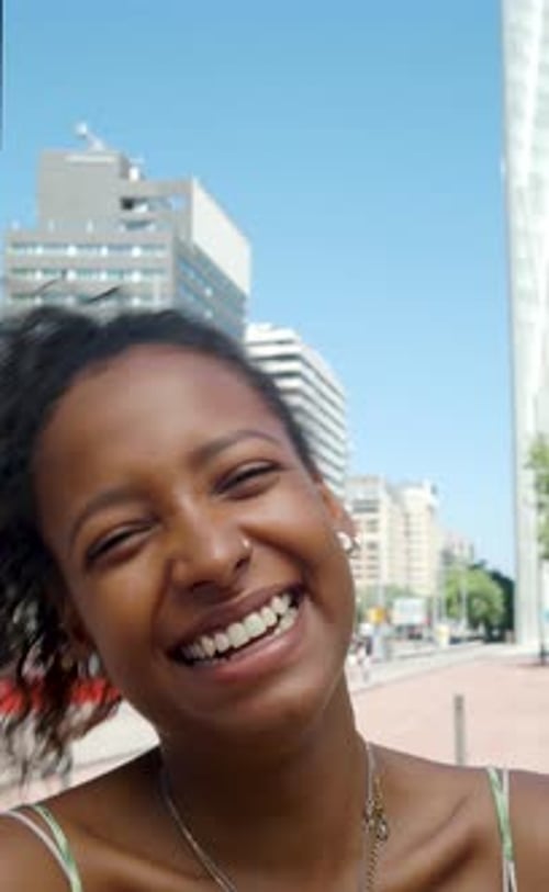 Vertical Video Portrait of a Smiling Young African American Woman Tourist on Vacation in a City