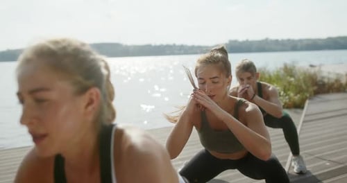 Women Exercising Together Outdoors in a Park