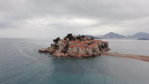 AERIAL - Sveti Stefan island luxury resort, tombolo, on the Adriatic Sea, Montenegro