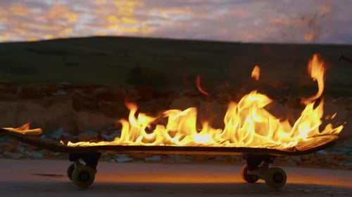 Skateboard Ablaze with Fiery Flames at Sunset
