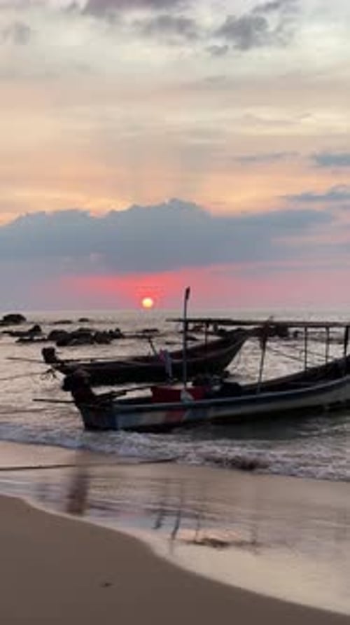 Sunset Fishing Boats on a Quiet Sandy Beach
