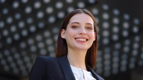 Smiling Young Woman Wearing Business Attire Outside