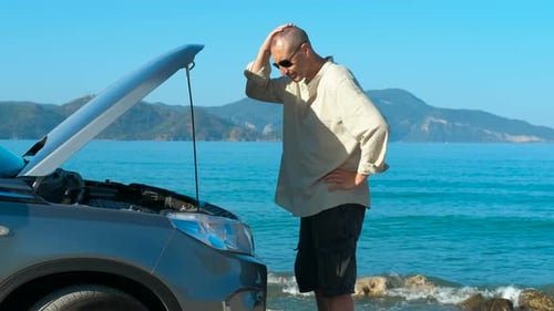 Tourist Looking Confused Next to Broken Car