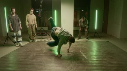 Young Man Breakdancing In Urban Setting With Green Lights