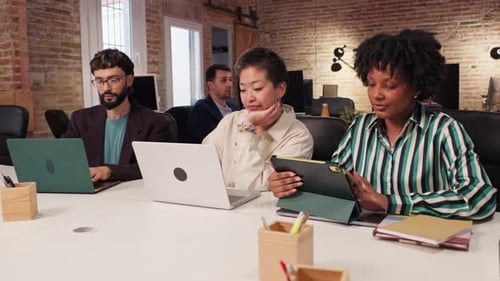 Coworkers Collaborating on Project in Modern Office