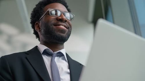 Smiling Happy African American Business Man Holding Laptop in Office Typing Working Businessman Male