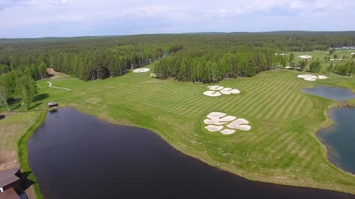 Stunning Aerial View of a Lush Golf Course Enhanced By Beautiful Water Features Nearby
