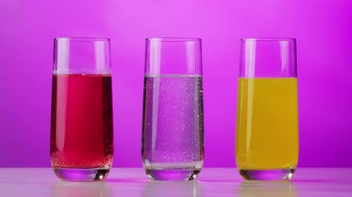 Three Colorful Drinks in Glasses on Pink Background