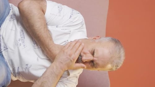 Man Clutches Throat in Pain