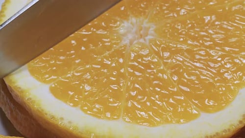 Close-up Slicing a Fresh Orange