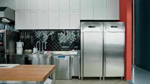 Professional commercial empty clean modern kitchen in restaurant or cafe Metal kitchen equipment