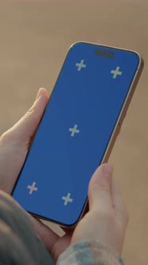 Smartphone With Blue Screen Held By Person