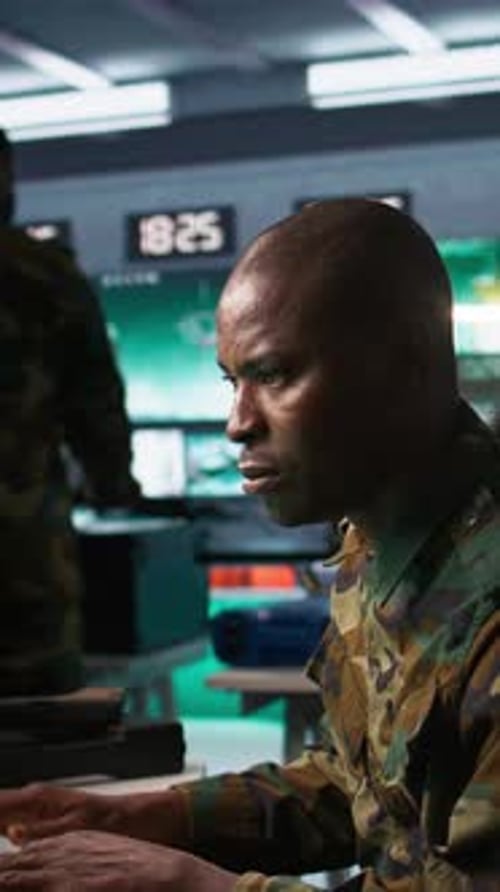 Man in Military Uniform Working at Computer Station