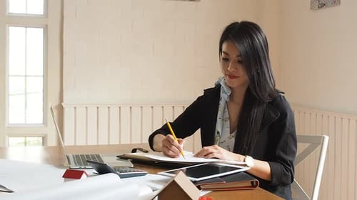 Adult Woman Drawing at Desk in Office