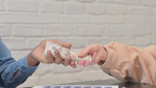 Close up of Woman Giving Money to African Man