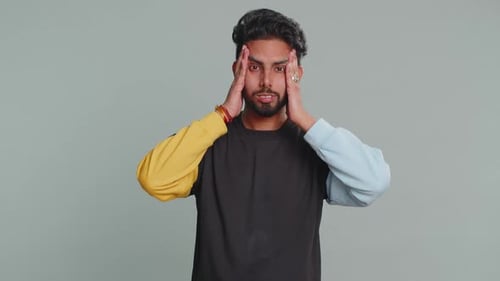 Young Adult Man Experiencing Headache and Stress