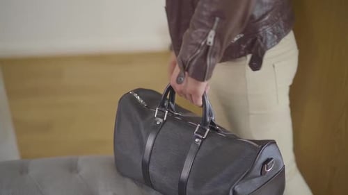 Man taking bag from the sofa Slow Motion