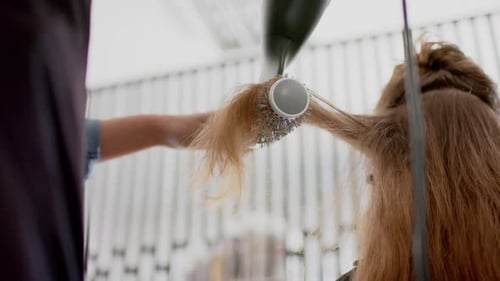 Woman Getting a Blowout in a Modern Hair Salon