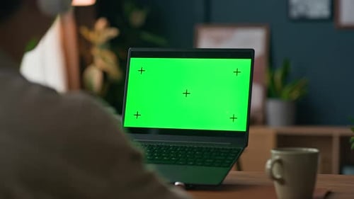 Freelance Worker Communicating during Video Call on Laptop with Green Screen