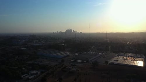 Drone Aerial Descend with the Downtown Los Angeles Skyline in the Background at Sunset, California,