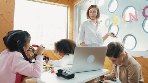 Kids Learning Coding in Classroom with Teacher