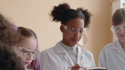 Students Wearing Safety Goggles Working in Science Classroom