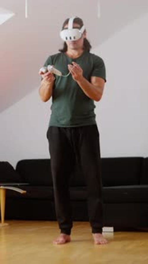 Man Using VR Headset and Controllers Indoors