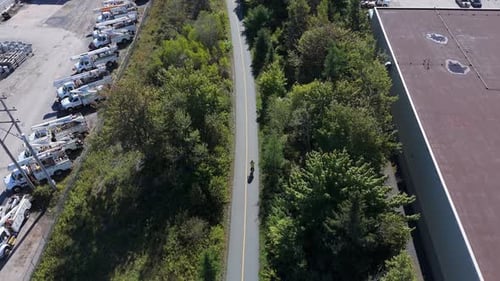 Drone View Of Cyclist Woman Training On Bike In Green City Park Nova Scotia