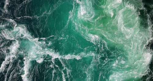 Blue waves of water of the river and the sea meet each other during high tide and low tide.