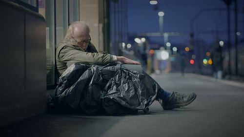 Elderly Homeless Man Suffering From Poverty Looking for Help at Train Station
