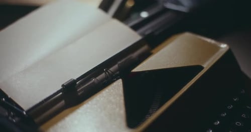 Vintage Typewriter Typing on Paper in Workplace