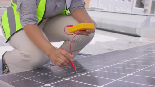 Solar panels, multimeter and engineering hands for power check, installation or maintenance