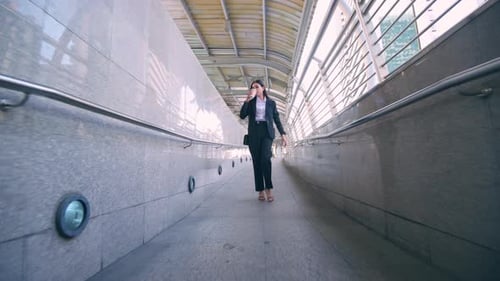 A young business woman wearing black suit hurry up during morning rush hour
