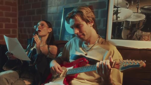 Guitarist Accompanying to Vocalist While Recording Song in Studio