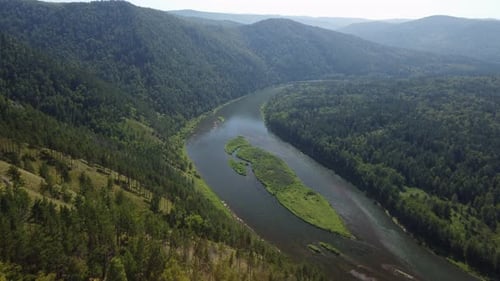 Awesome aerial view of scenic river among evergreen woods