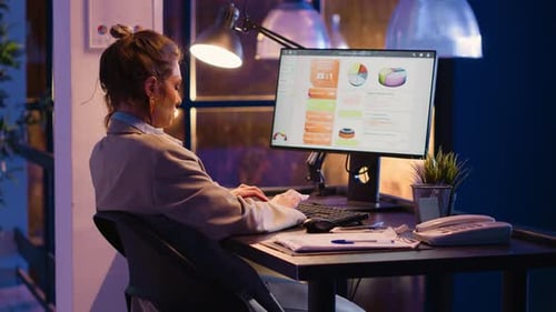 Female Manager Working on Financial Statistics in Office