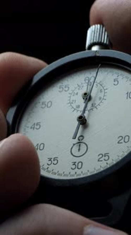 Strong Male Hand Starts Stopwatch As Seconds Begin to Pass