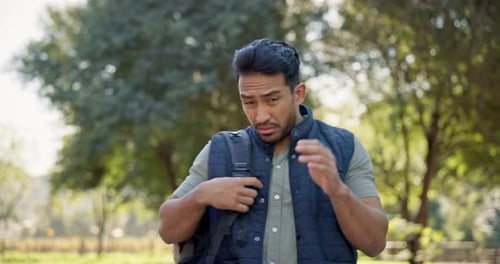 Hiking, man and scared of bees outdoor in a forest for travel, trekking or adventure