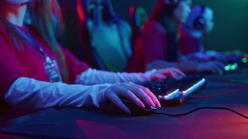 Hands of Female Gamers Playing Video Game in Cyberclub